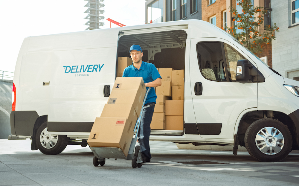 A delivery driver making a delivery of several packages.